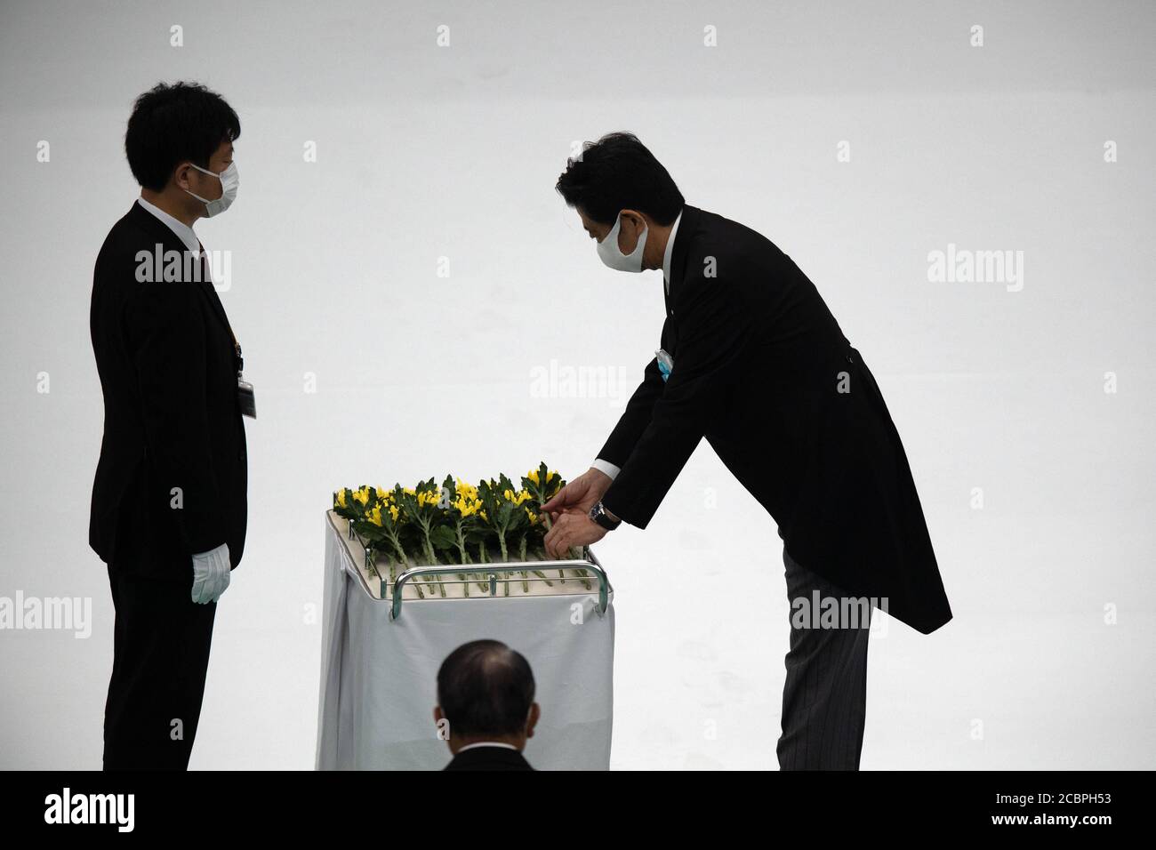Tokyo, Japan. 15th Aug, 2020. TOKYO, JAPAN - AUGUST 15: Japan's Japan's Prime Minister, Shinzo Abe, prepares to lay a flower during a memorial service marking the 75th anniversary of Japan's surrender in World War II at the Nippon Budokan hall on August 15, 2020 in Tokyo, Japan. 75 years ago today and following the atomic bomb attacks on Hiroshima and Nagasaki, former emperor Hirohito formally announced Japan's surrender to allied forces, bringing the hostilities of World War II to an end. Credit: POOL/ZUMA Wire/Alamy Live News Stock Photo