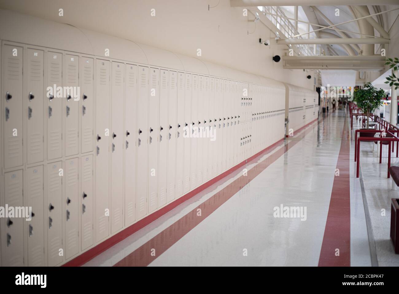 Beige school lockers in empty high school hallway Stock Photo