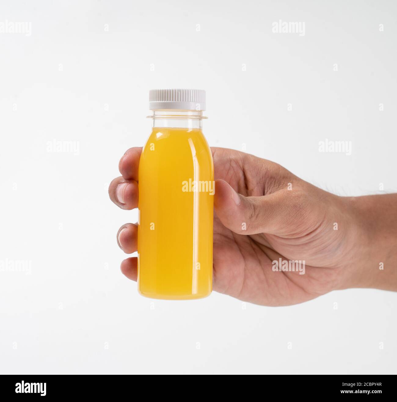 https://c8.alamy.com/comp/2CBPY4R/hand-holding-fruit-juice-on-a-plastic-bottle-product-mockup-2CBPY4R.jpg