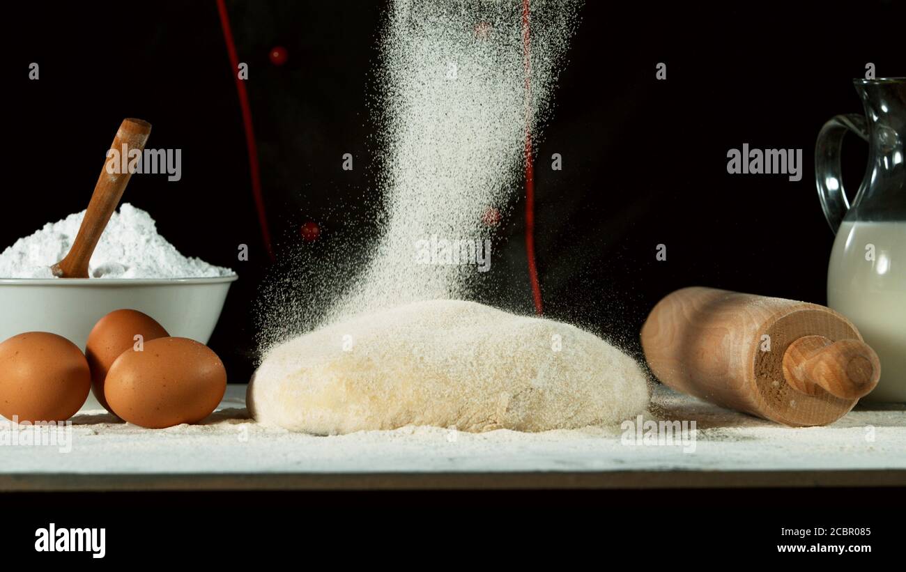 Freeze motion of pouring flour on yeast dough. Food preparation concept ...