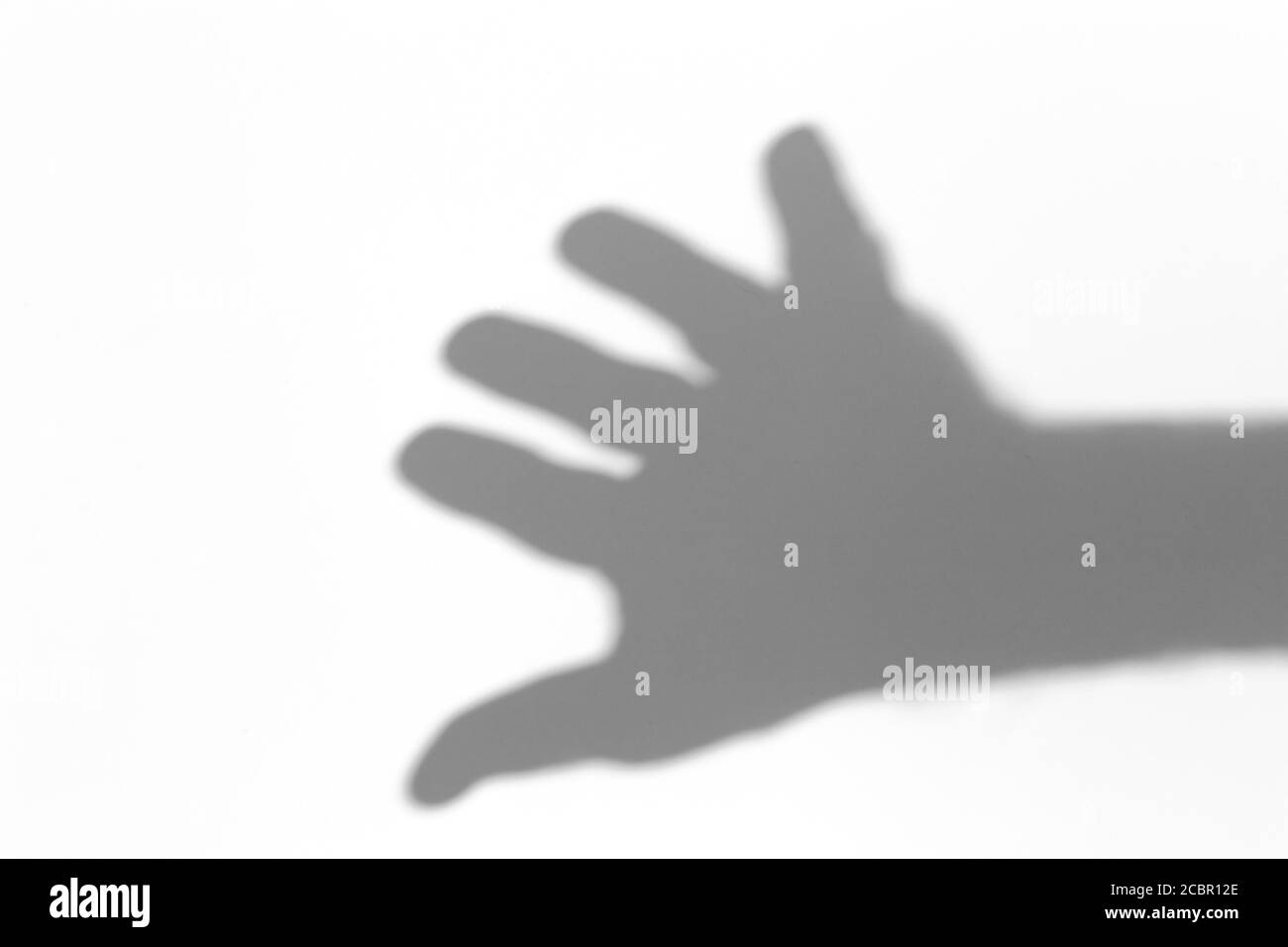 Shadow overlay effect for photo. Shadows from hand palms on white light wall in sunlight. Stock Photo