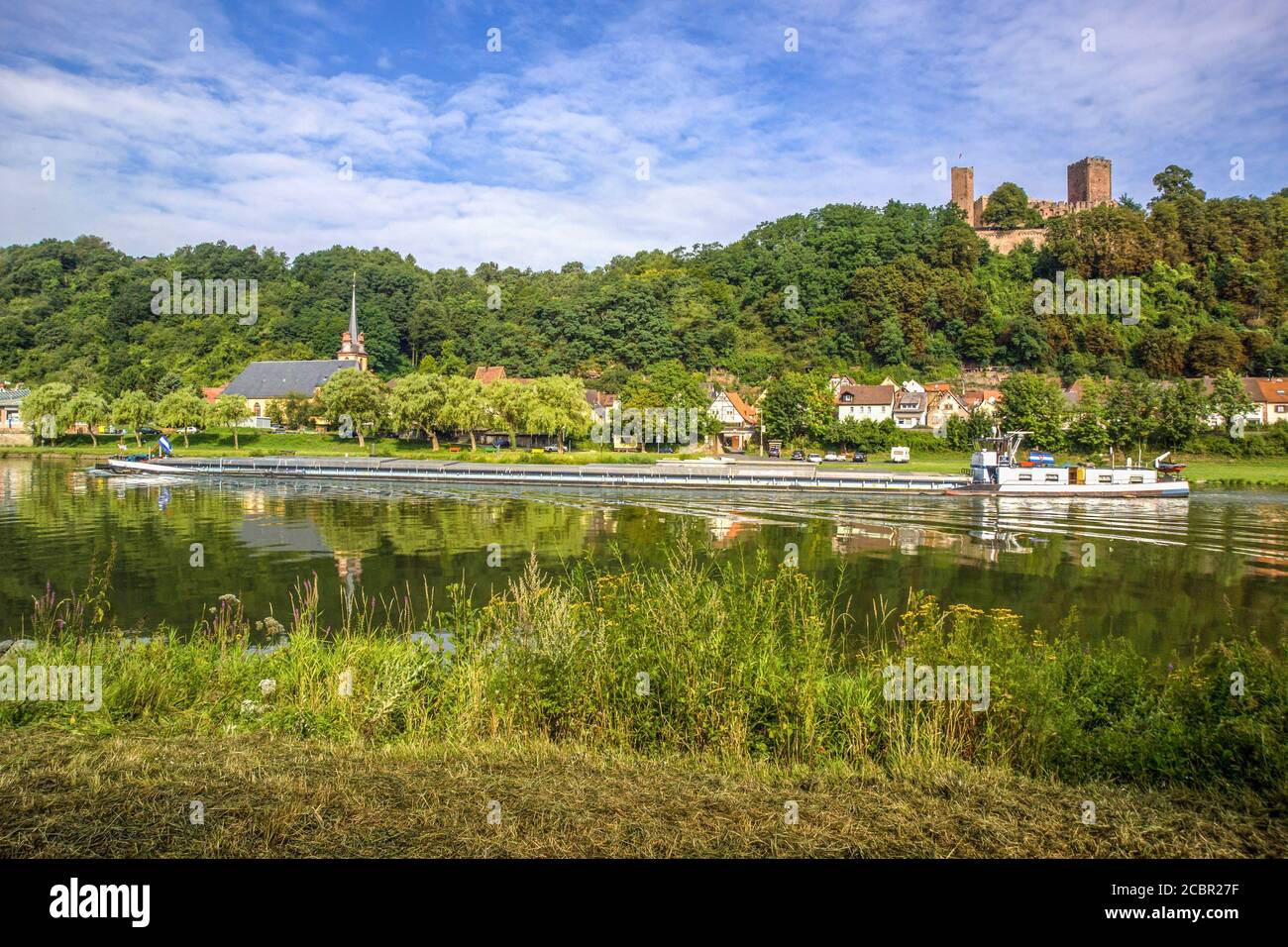 GERMANY HENNEBURG. A cargo ship navigating the Main river below castle Henneburg in Bavaria Stock Photo