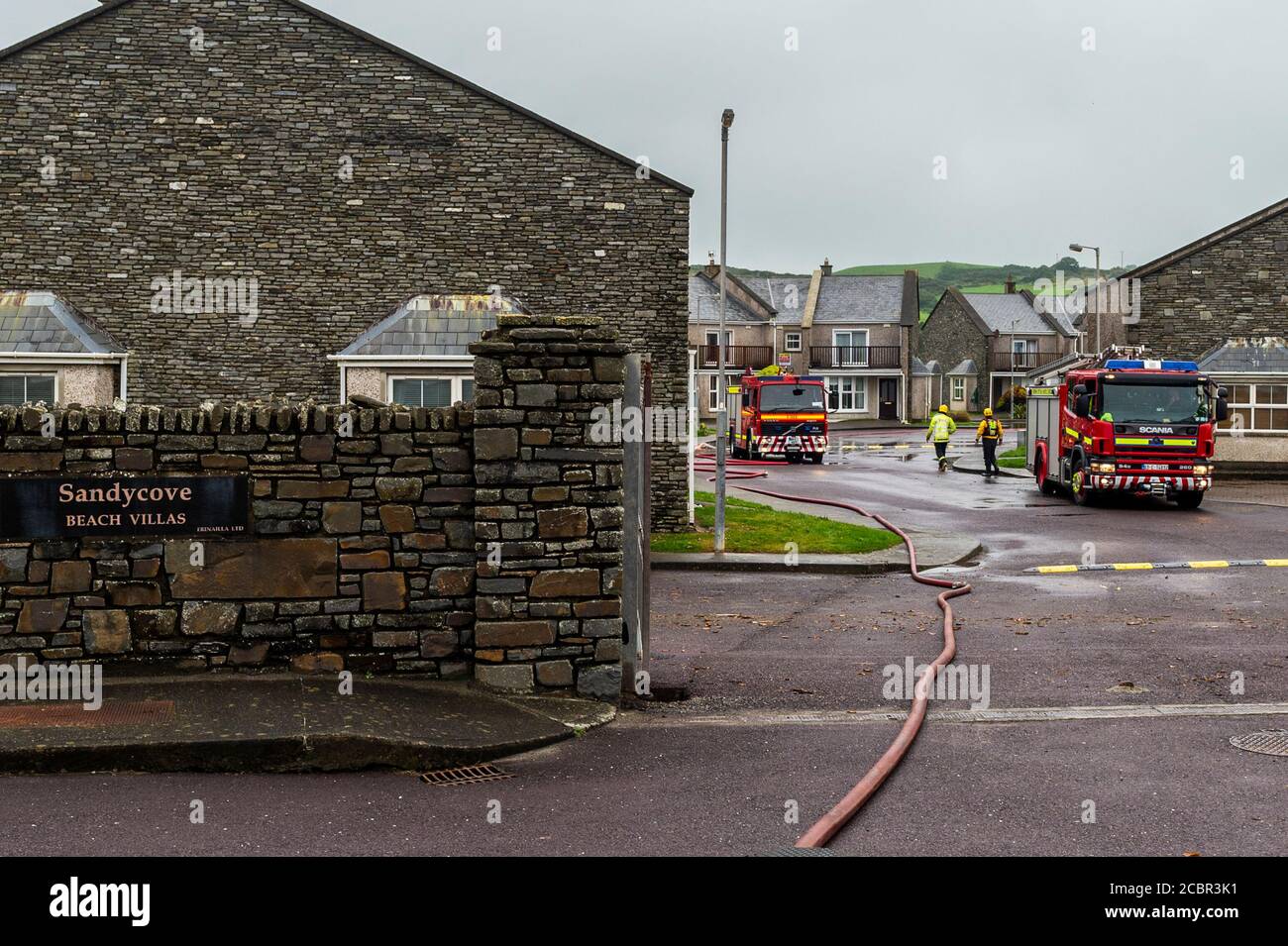 Owenahincha, West Cork, Ireland. 15th Aug, 2020. Firefighters start to pack away their equipment after spending most of the night at Sandycove Beach Villas pumping flood water in a successful attempt to stop the houses becoming overrun with water. Credit: AG News/Alamy Live News Stock Photo