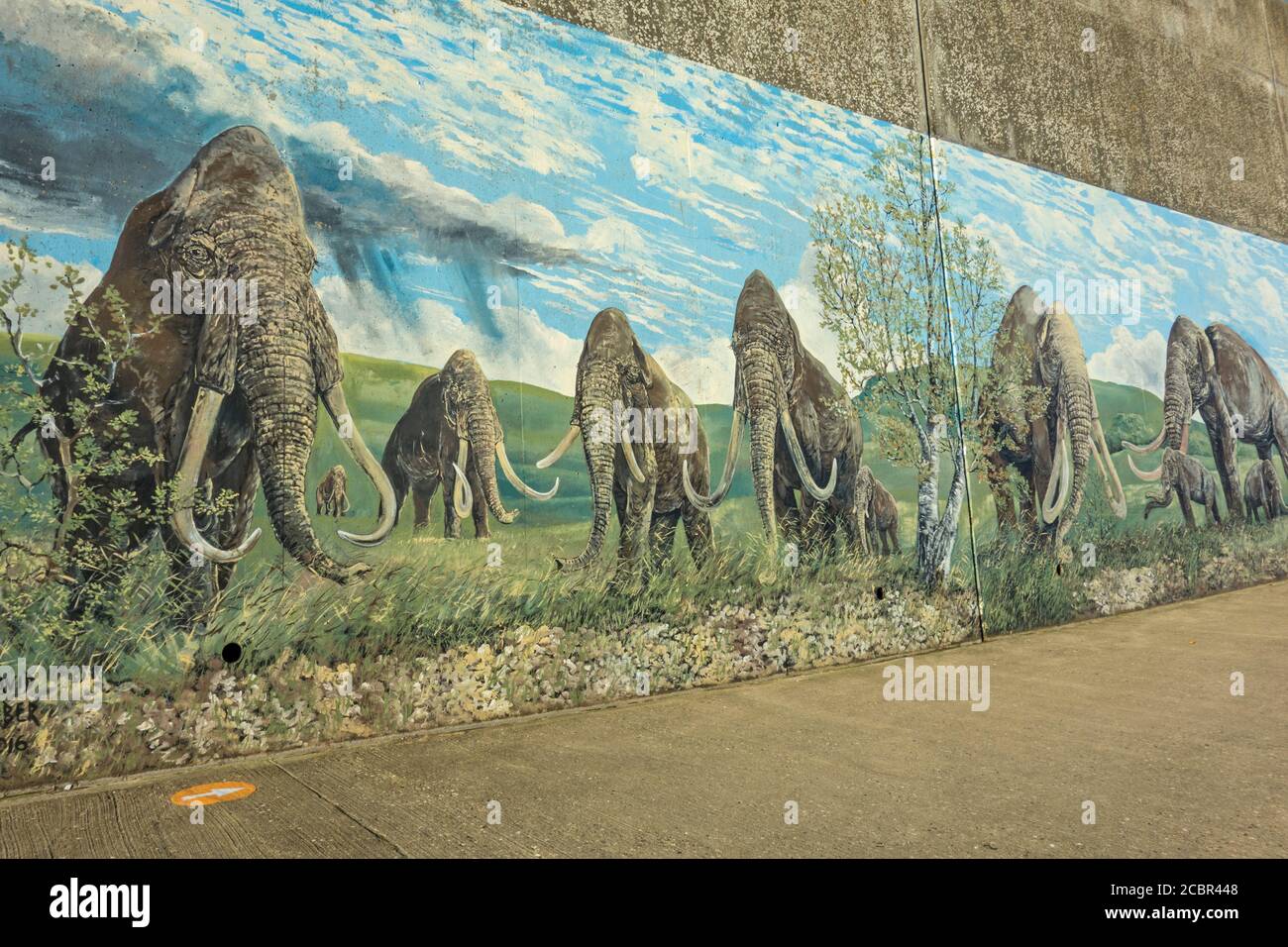 Wall art on Sheringham promenade with a Neolithic mammoth theme, Sheringham, Norfolk, England Stock Photo