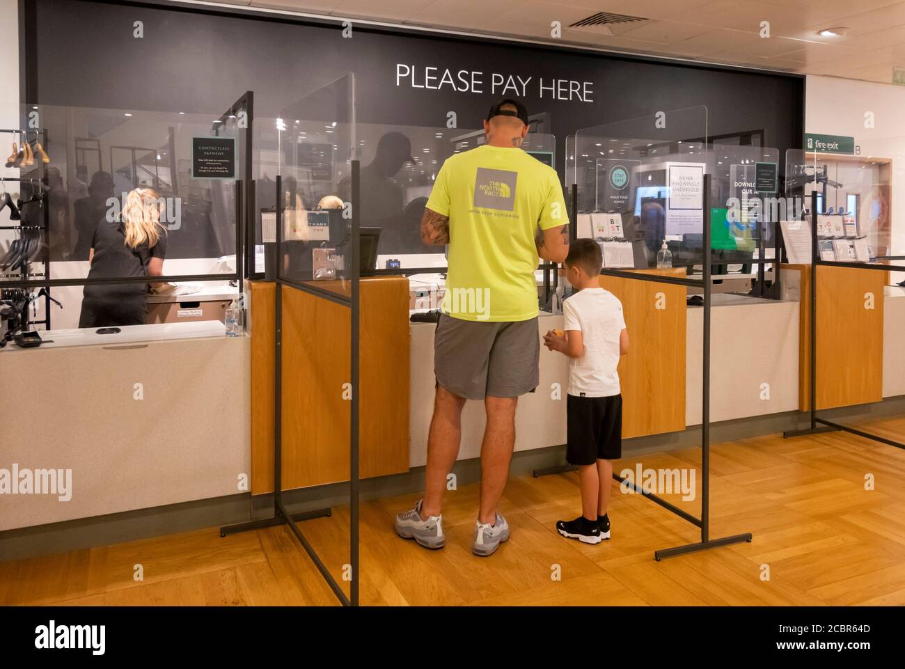 Father and son at John Lewis check out in Liverpool Stock Photo