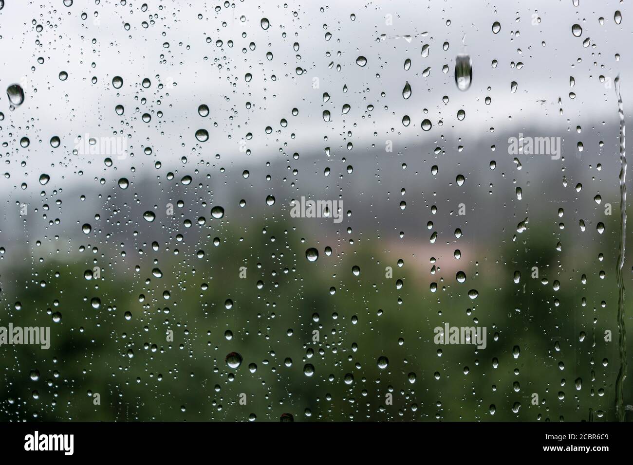 drops of water on the glass on a rainy day, glass with drops of water ...