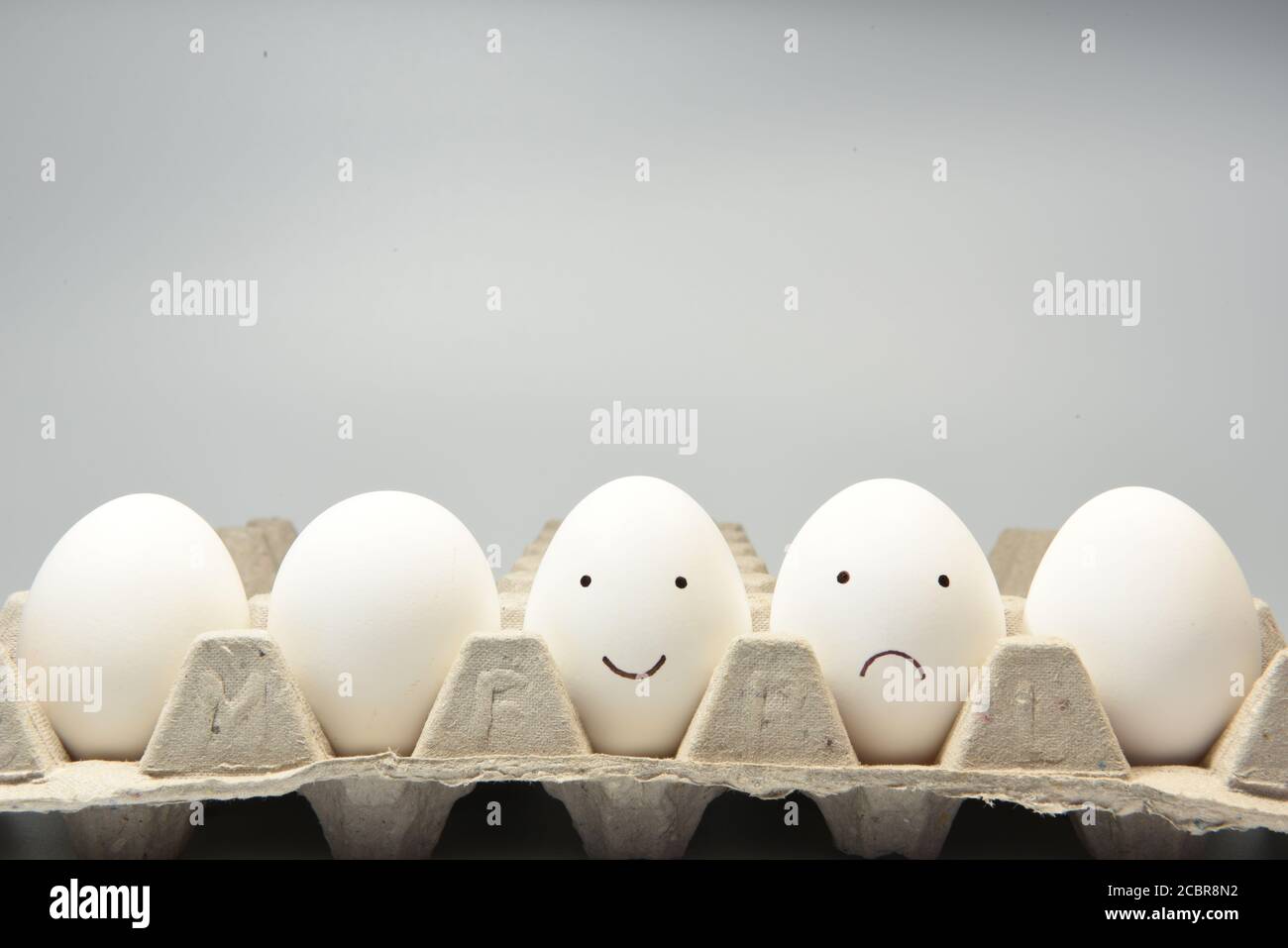 Happy face smiley and sad face smiley on egg shells Stock Photo