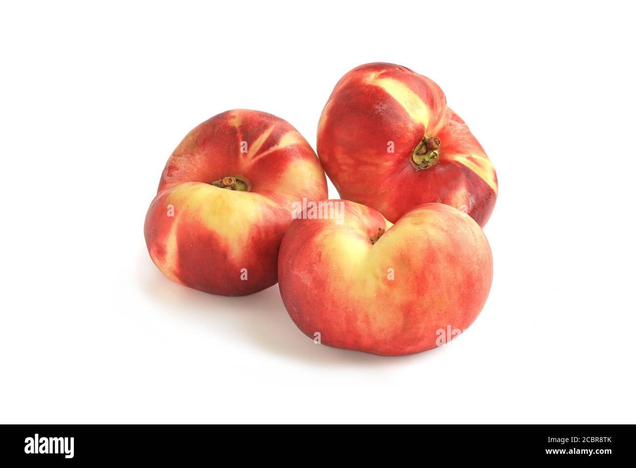 Three flat fig peaches isolated on white background Stock Photo