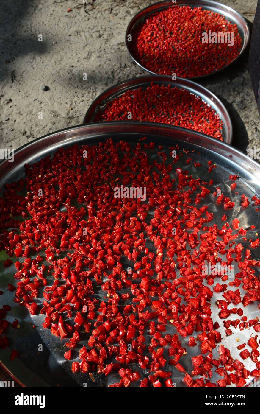 A view of steel plates, with drying red pepper Stock Photo