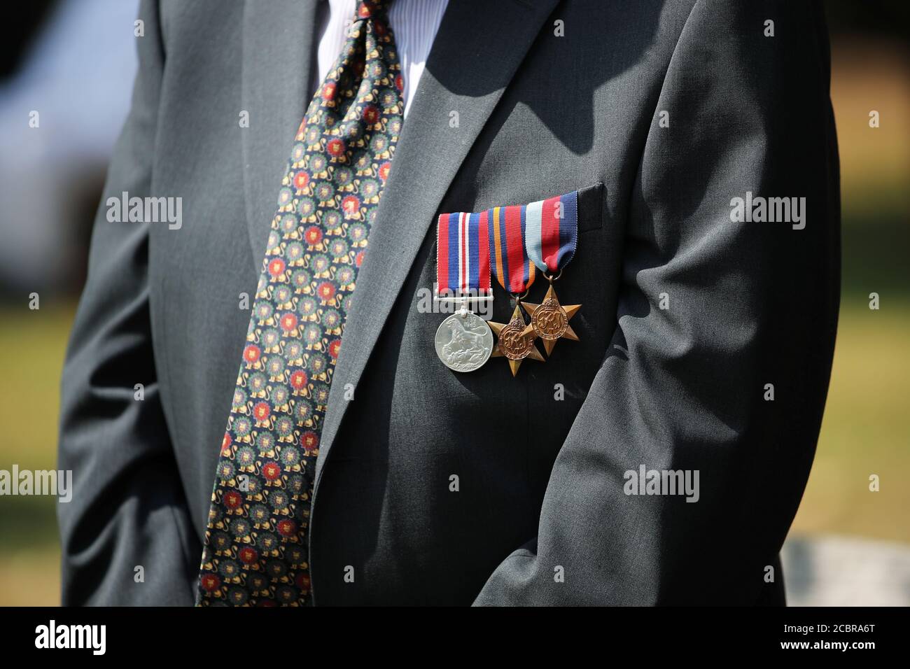 Medals are pictured on a World War Two veteran's jacket during the national service of remembrance marking the 75th anniversary of VJ Day at the National Memorial Arboretum in Alrewas, Staffordshire. Stock Photo