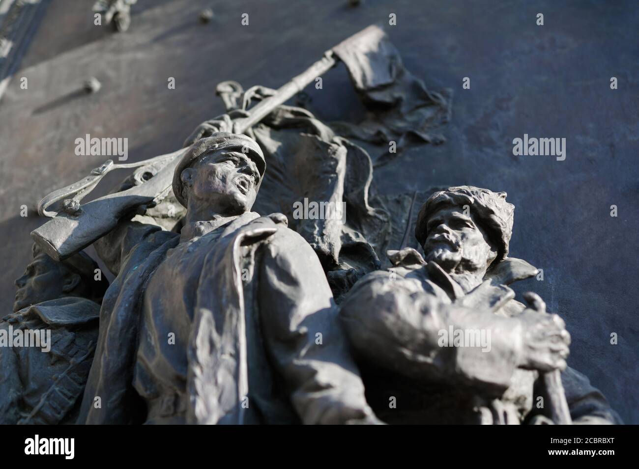 Memorial with statues of soldiers in war - gesture of brave yelling combatant - attack and offense to defeat enemy Stock Photo