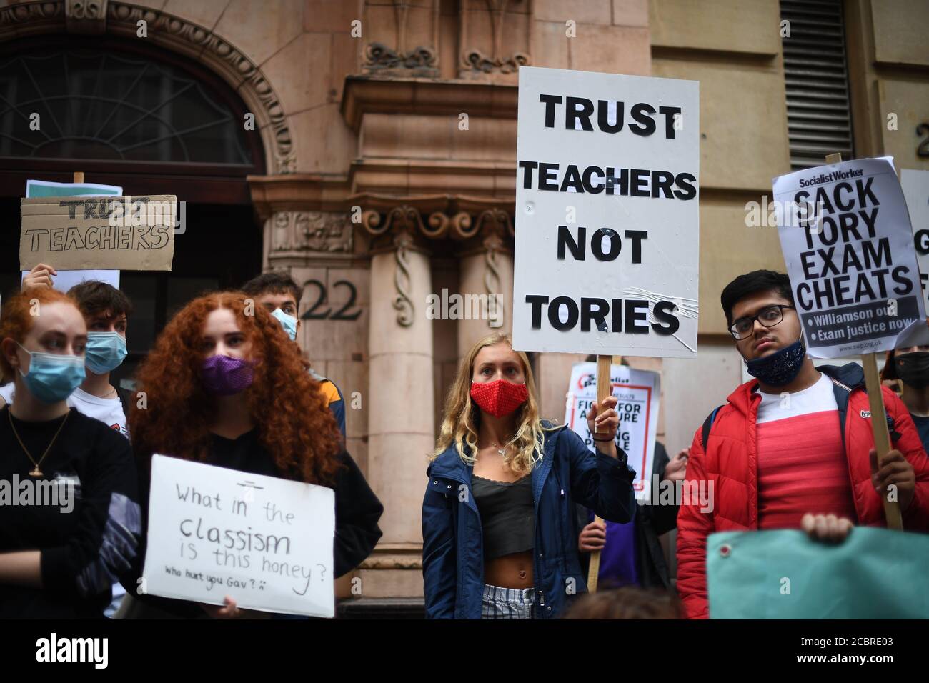 Demonstrators joining Young Socialists hold up placards outside the Department for Education, London as they protest the handling of exam results, university provision and bleak employment prospects. Stock Photo