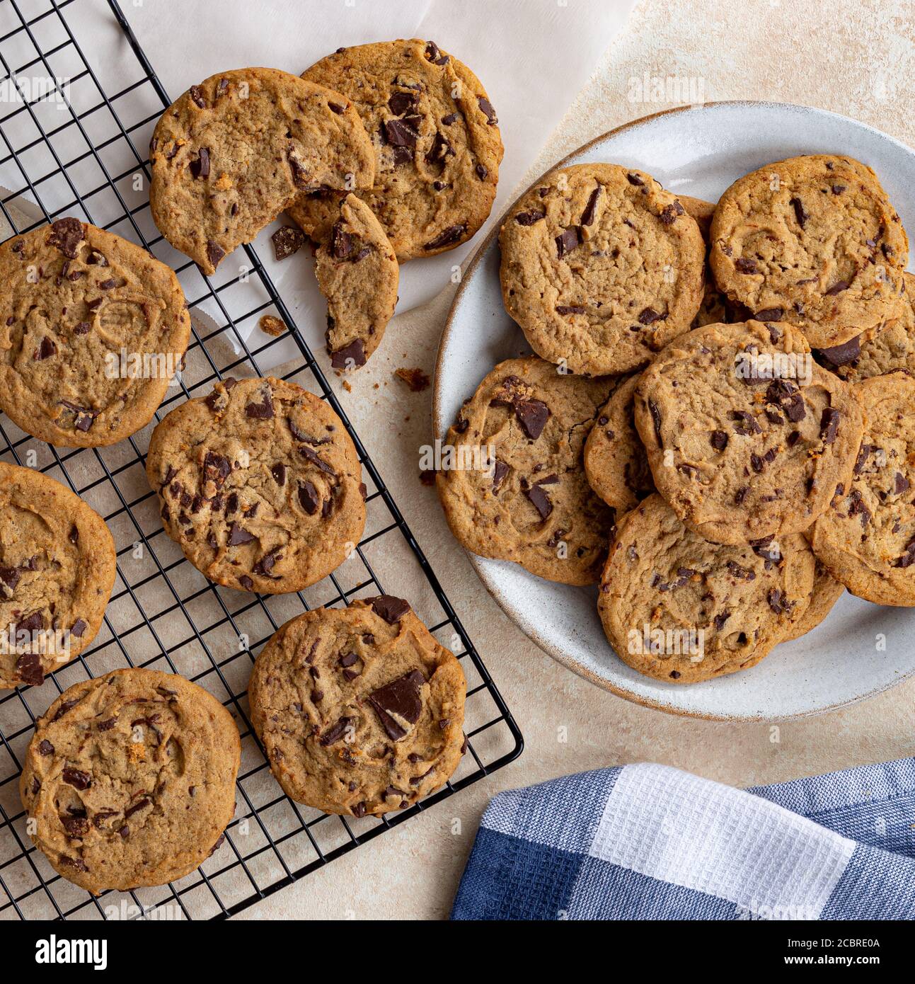 Overhead of chocolate chip cookies on a plate and cooling rack Stock Photo