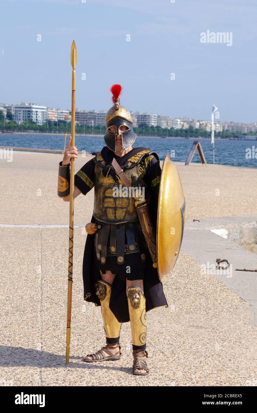 Man dressed as an ancient Greek hoplite soldier to attract customers onto a mini-cruise in Thessaloniki Greece - Photo: Geopix/Alamy Stock Photo Stock Photo