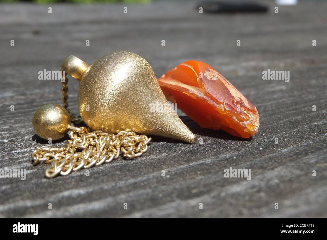 golden pendulum with red stone Stock Photo
