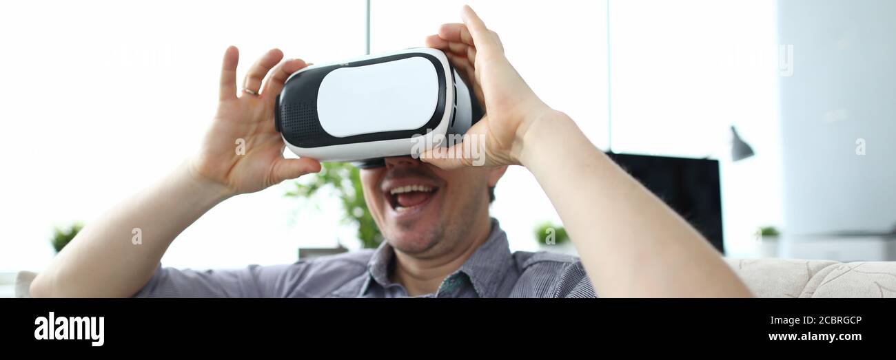 Guy using VR at home Stock Photo