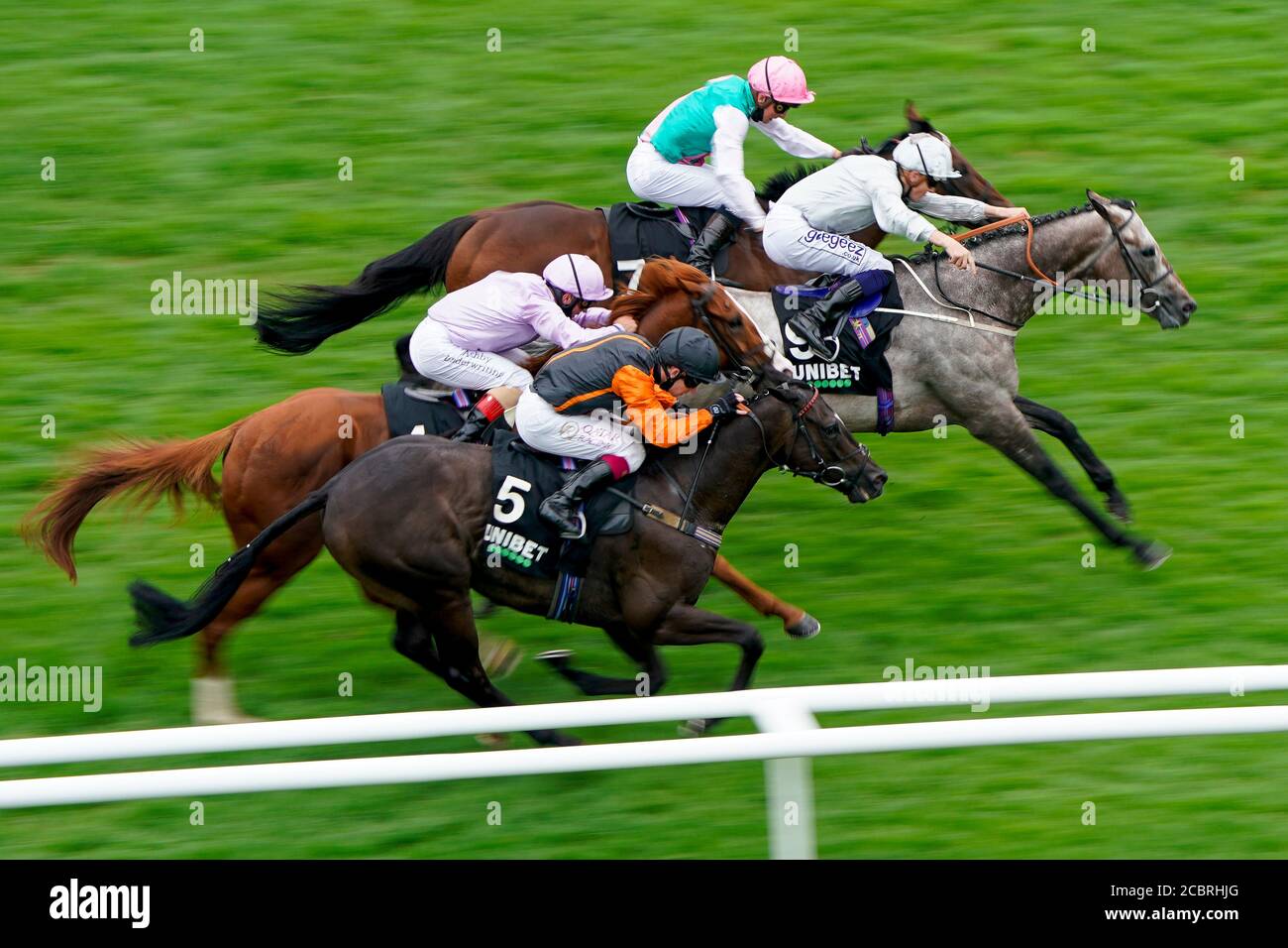 Tempus ridden by Jason Watson (top) win The Unibet You're On Handicap after originally finishing second to Overwrite ridden by David Probert at Newbury Racecourse. Stock Photo