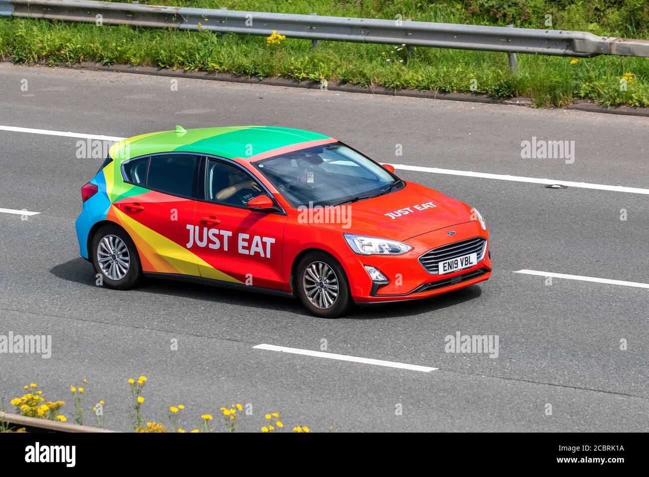 Just Eat online foods delivery 2019 Ford Focus Titanium TDCI ; Vehicular traffic moving vehicles, commercial vans, food courier on the Just Eat network, takeaway business vehicle, cars driving vehicle on UK roads, motors, motoring on the M6 motorway highway network. Stock Photo