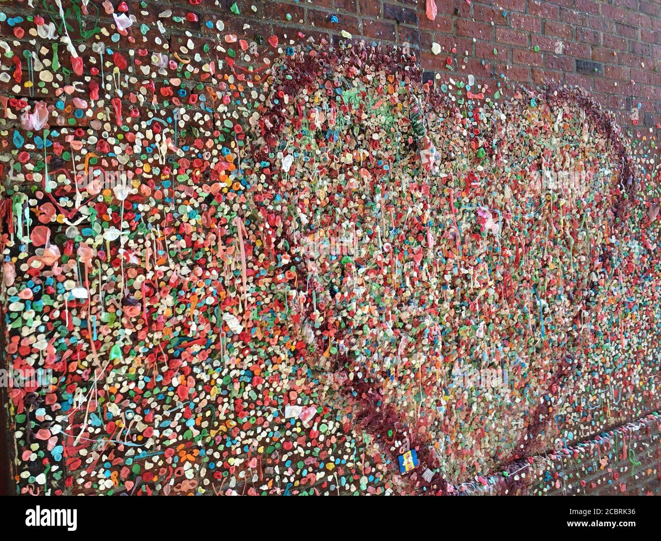 The Market Theatre wall covered with colourful chewing gum at Post Alley, Downtown Seattle. Washington State. Stock Photo