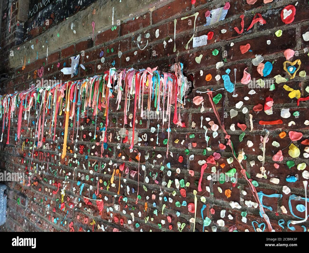 The Market Theatre wall covered with colourful chewing gum at Post Alley, Downtown Seattle. Washington State. Stock Photo