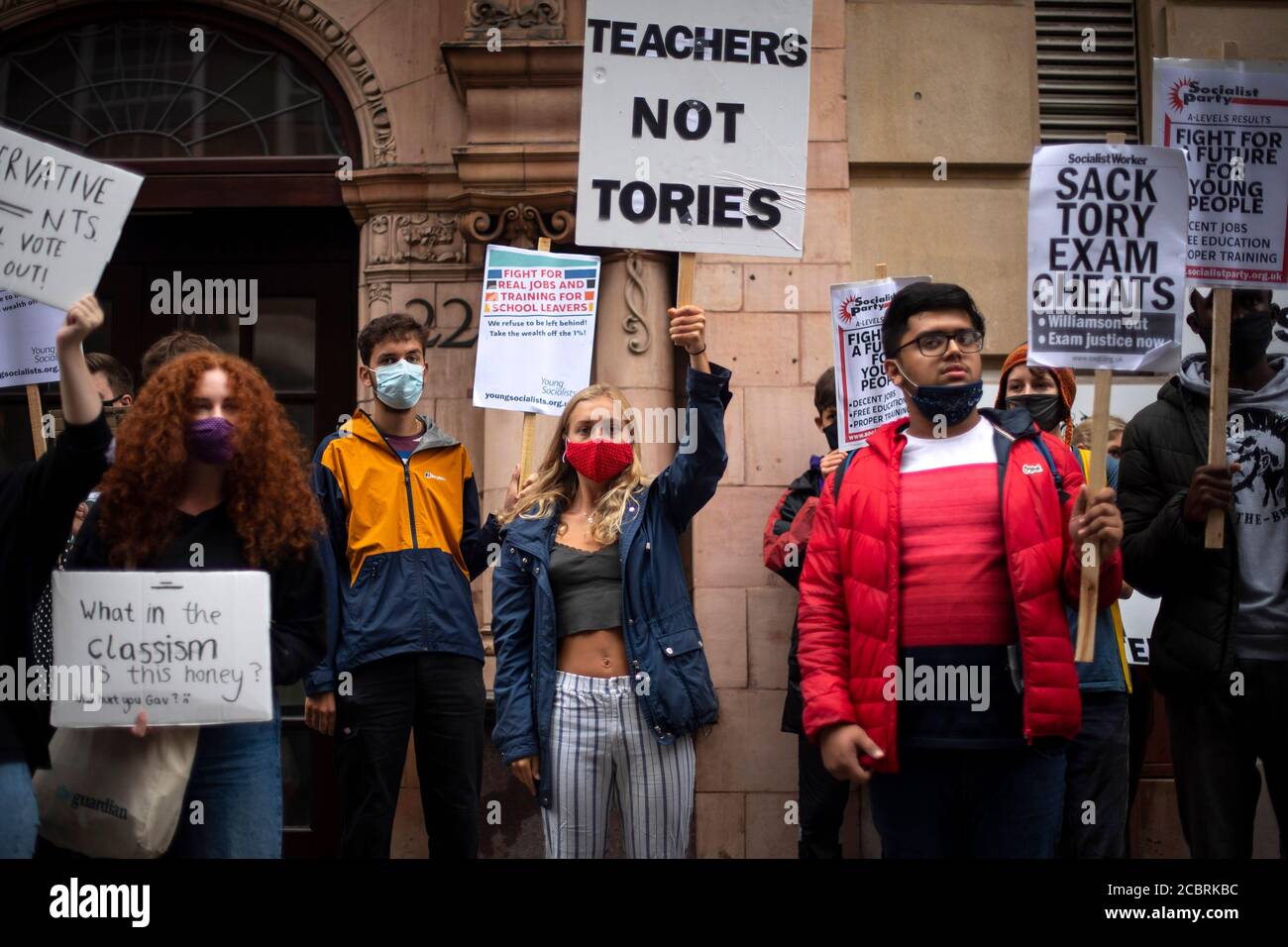 Students wearing face masks take part in a protest in Westminster in London over the government's handling of A-level results, university provision and bleak employment prospects. Stock Photo