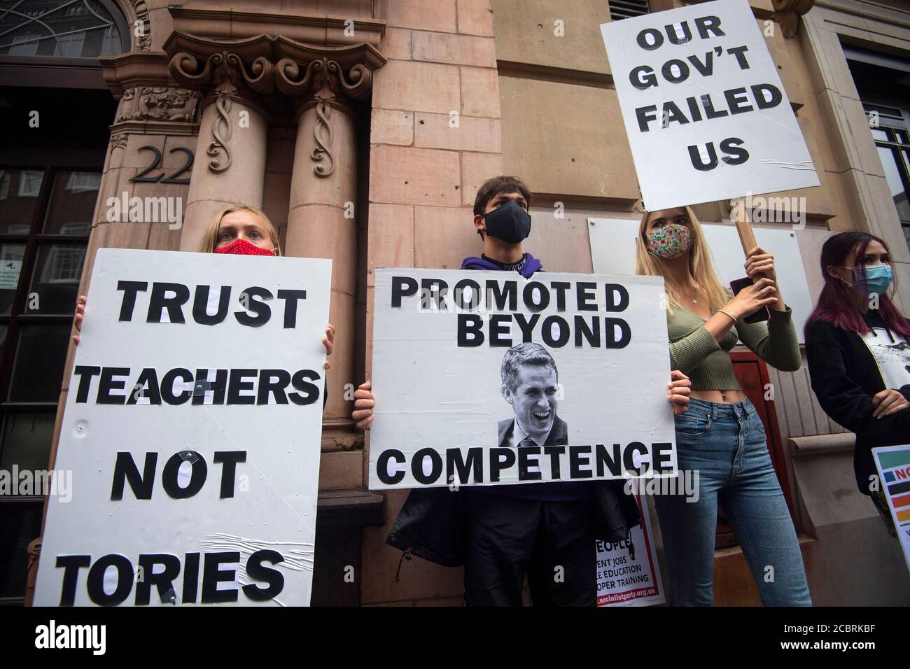 Students wearing face masks take part in a protest in Westminster in London over the government's handling of A-level results, university provision and bleak employment prospects. Stock Photo