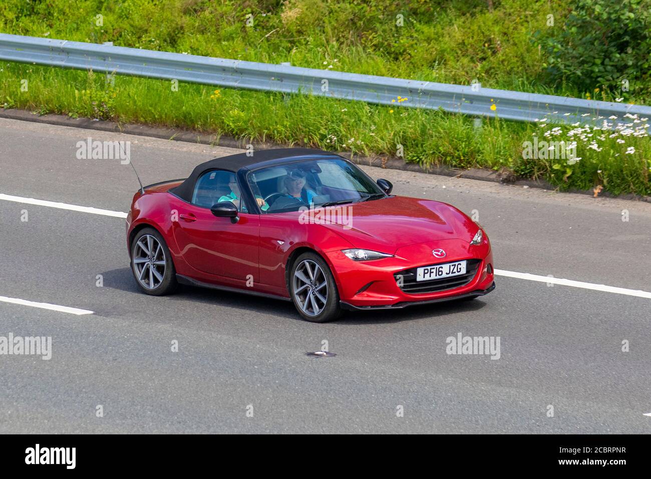 2016 Mazda Red Mx-5 Sport Recaro the most expensive version of Mazda's roadster ; Vehicular traffic moving vehicles, cars driving vehicle on UK roads, motors, motoring on the M6 motorway highway network. Stock Photo