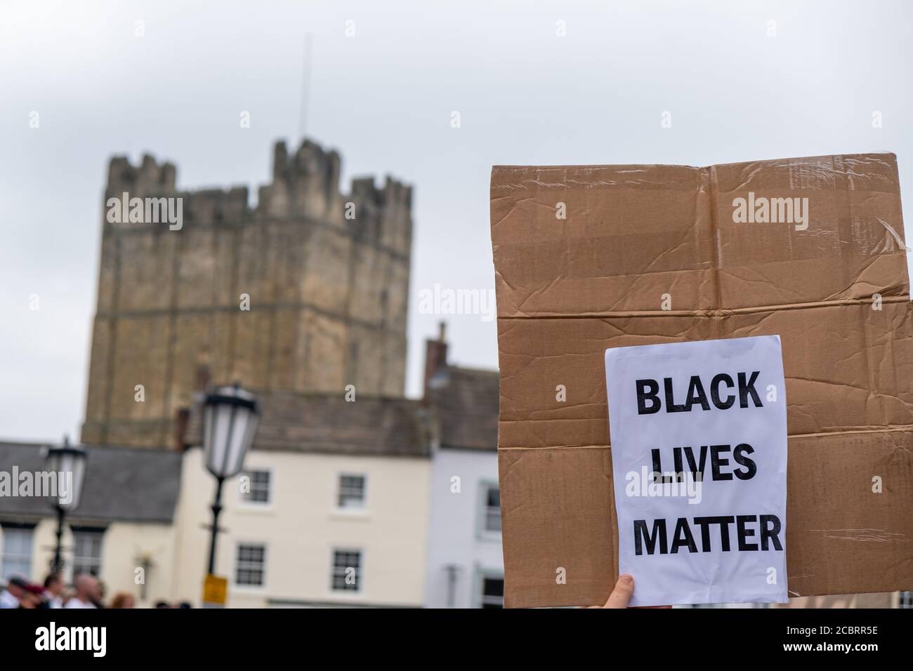 Richmond, North Yorkshire, UK - June 14, 2020: A Black Lives Matter sign held up in front of Richmond Castle at a protest in Richmond, North Yorkshire Stock Photo