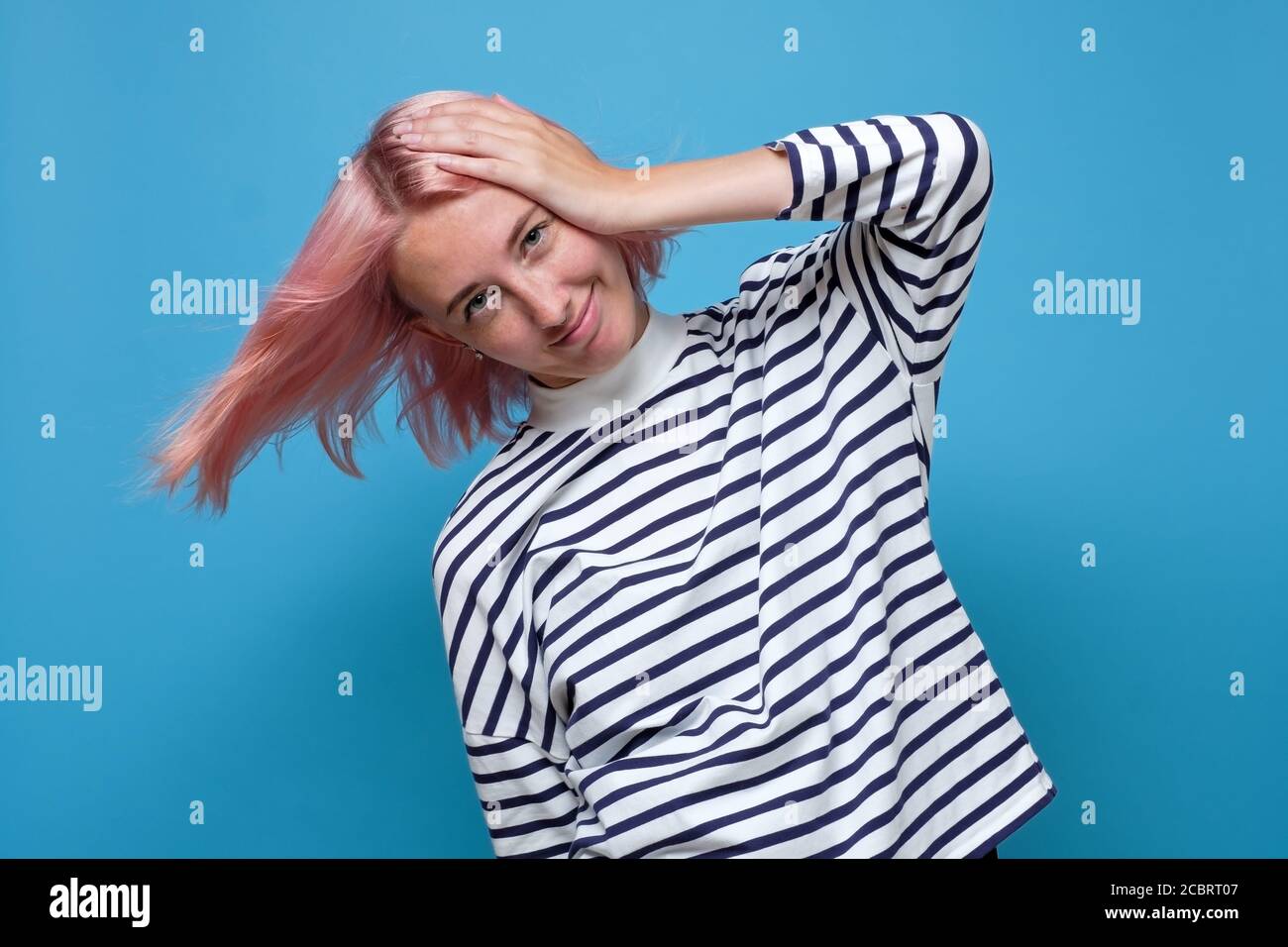 Young woman forgetting something, slapping forehead with palm. Stock Photo