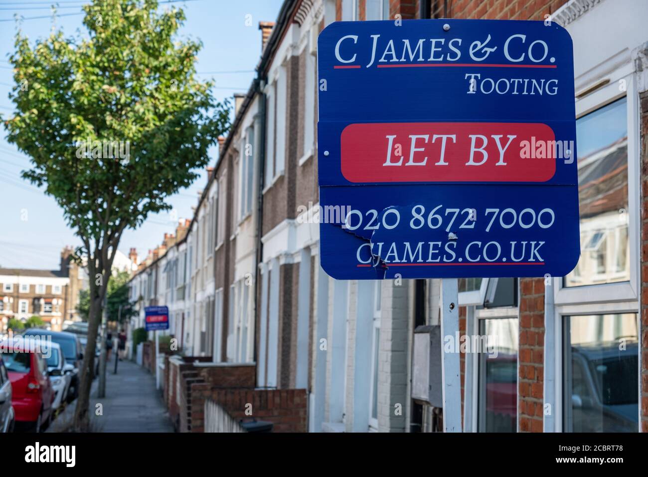 Estate agent sign on street of houses in Tooting, south west London Stock Photo