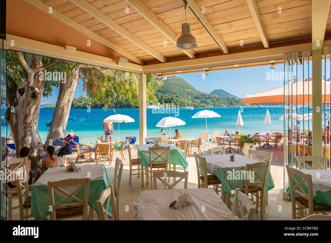 Looking out at the beach from inside a taverna in Nidri, Lefkada, Ionian Islands, Greece Stock Photo