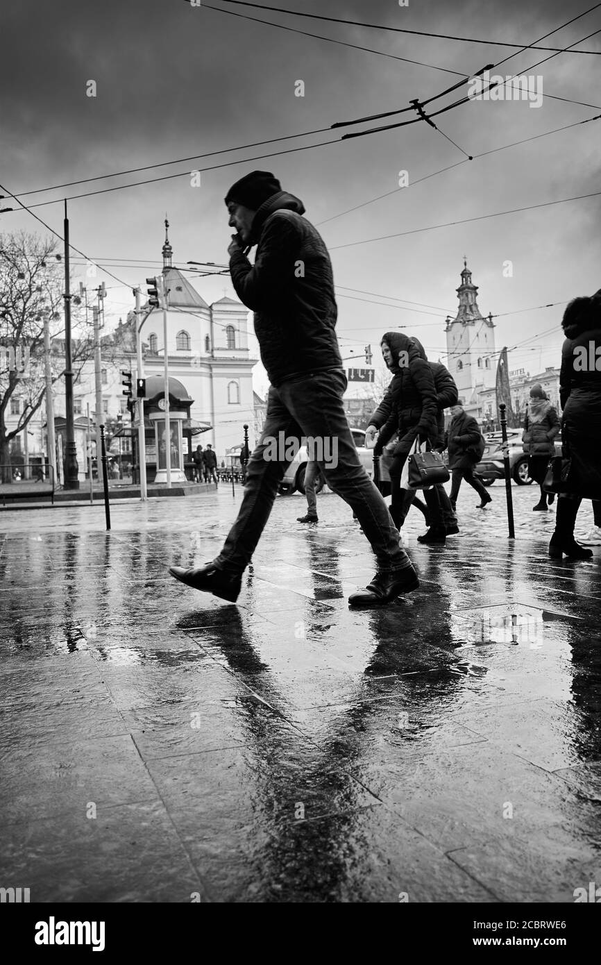 Lviv's passers-by. Lviv's townspeople. Lviv/Ukraine - January 30, 2020: Passersby walk down the Prospect Svobody. Stock Photo