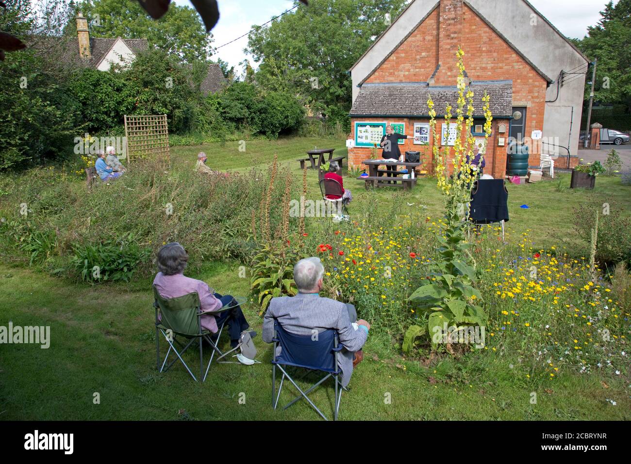 Methodist church service taking place in church garden during coronavirus cris with social distancing observed Mickleton UK Stock Photo