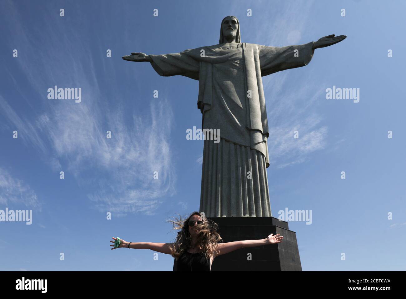 A Tourist Poses For A Picture With Open Arms During The Reopening Of The Christ The Redeemer Statue After Months Long Closure Due To The Outbreak Of The Coronavirus Disease Covid 19 In Rio A Tourist Poses For A Picture With Open Arms During The Reopening Of The Christ The Redeemer Statue After Months Long Closure Due To The Outbreak Of The Coronavirus Disease Covid 19 In Rio