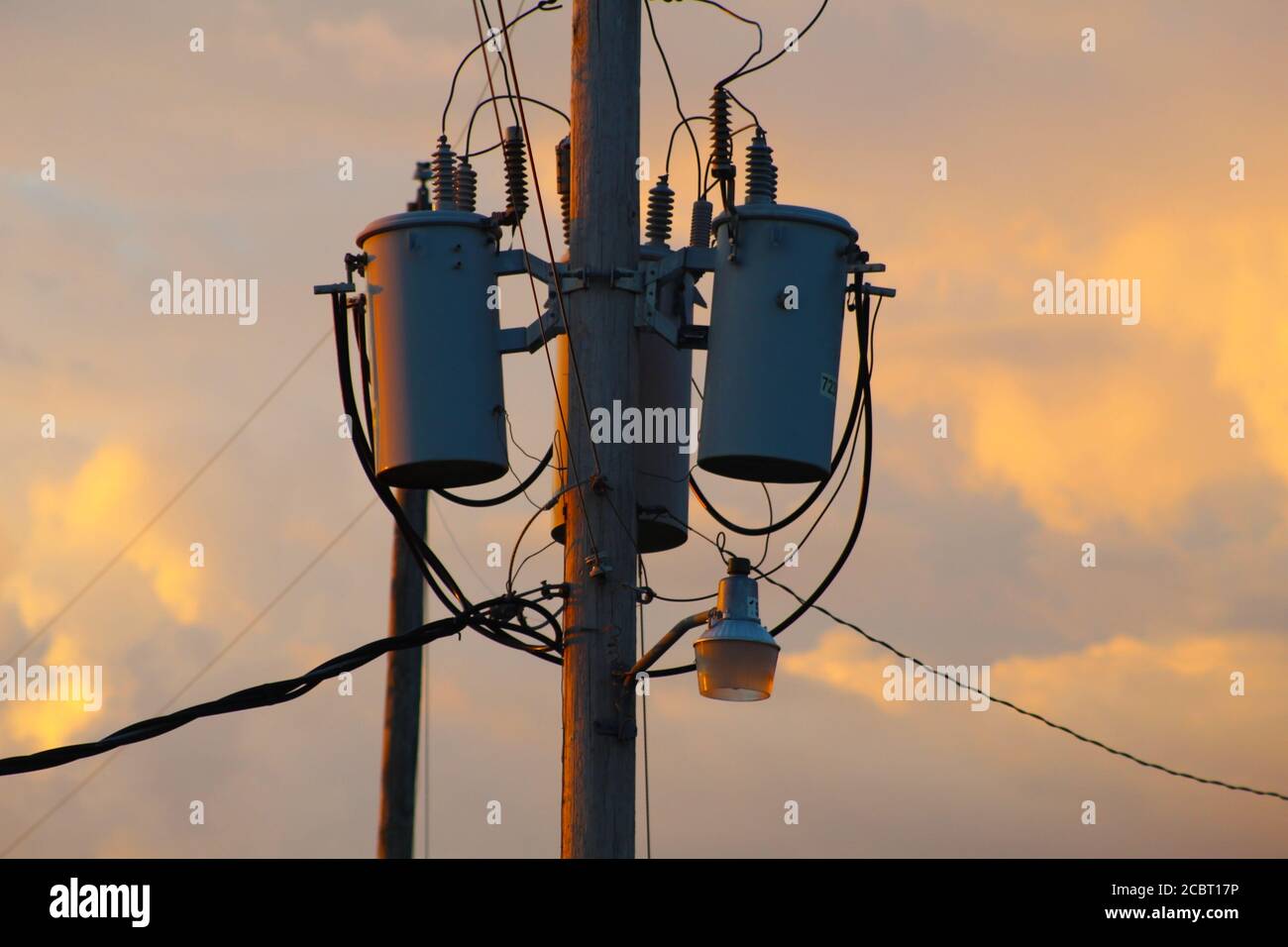 Telephone Pole With Light and Clouds in the Sky in the Ozarks, United States Stock Photo