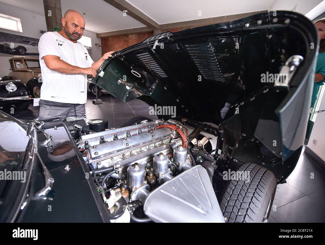 Trebic, Moravia. 11th Aug, 2020. Juraj Urbancik shows Jaguar E-Type's six-cylinder engine at the exposition dedicated to historical British sports cars Jaguar in Trebic, Moravia, Czech Republic, August 11, 2020. A long-time car fan Juraj Urbancik has been running the exhibition for about eight years. His collection of Jaguar cars is one of the largest in the country. Credit: Lubos Pavlicek/CTK Photo/Alamy Live News Stock Photo