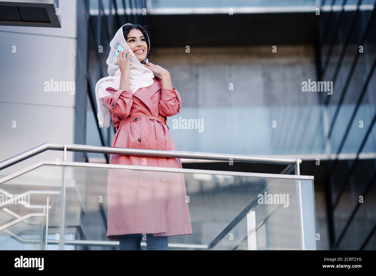 Young Muslim woman wearing hijab using her smartphone Stock Photo - Alamy