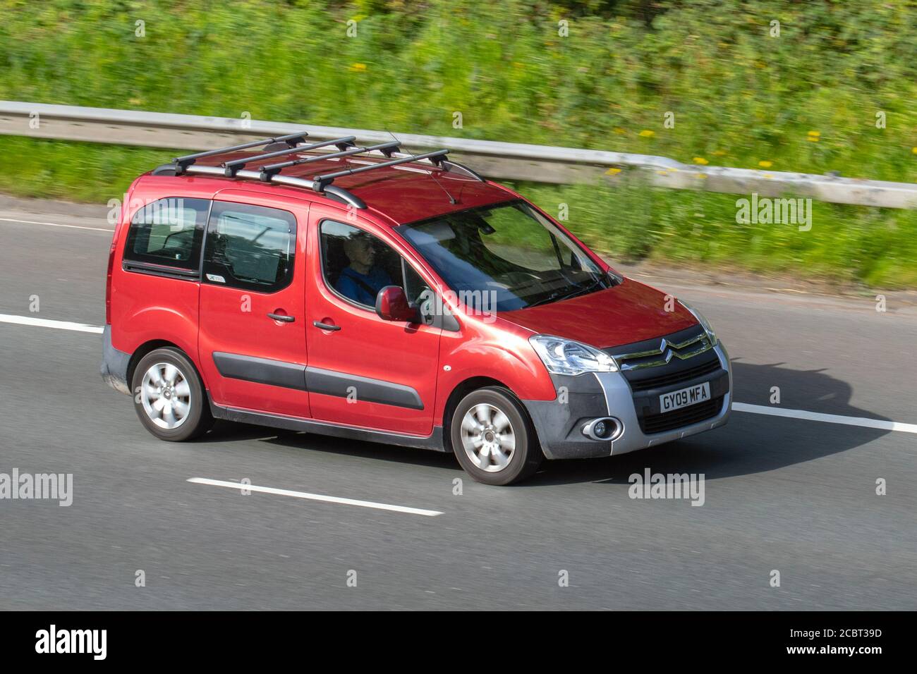 2009 Red Citroën Berlingo M-Sp XTR HDI 90; Vehicular traffic moving vehicles, cars driving vehicle on UK roads, motors, motoring on the M6 motorway highway network Stock Photo -
