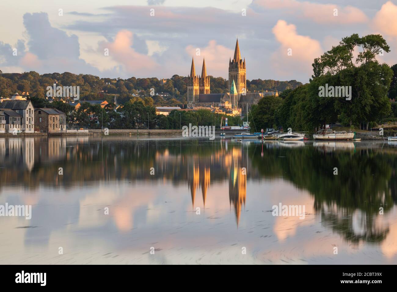 Truro Cathedral reflected in Truro River.  The image captured from Boscawen Park on a morning in early August. Stock Photo