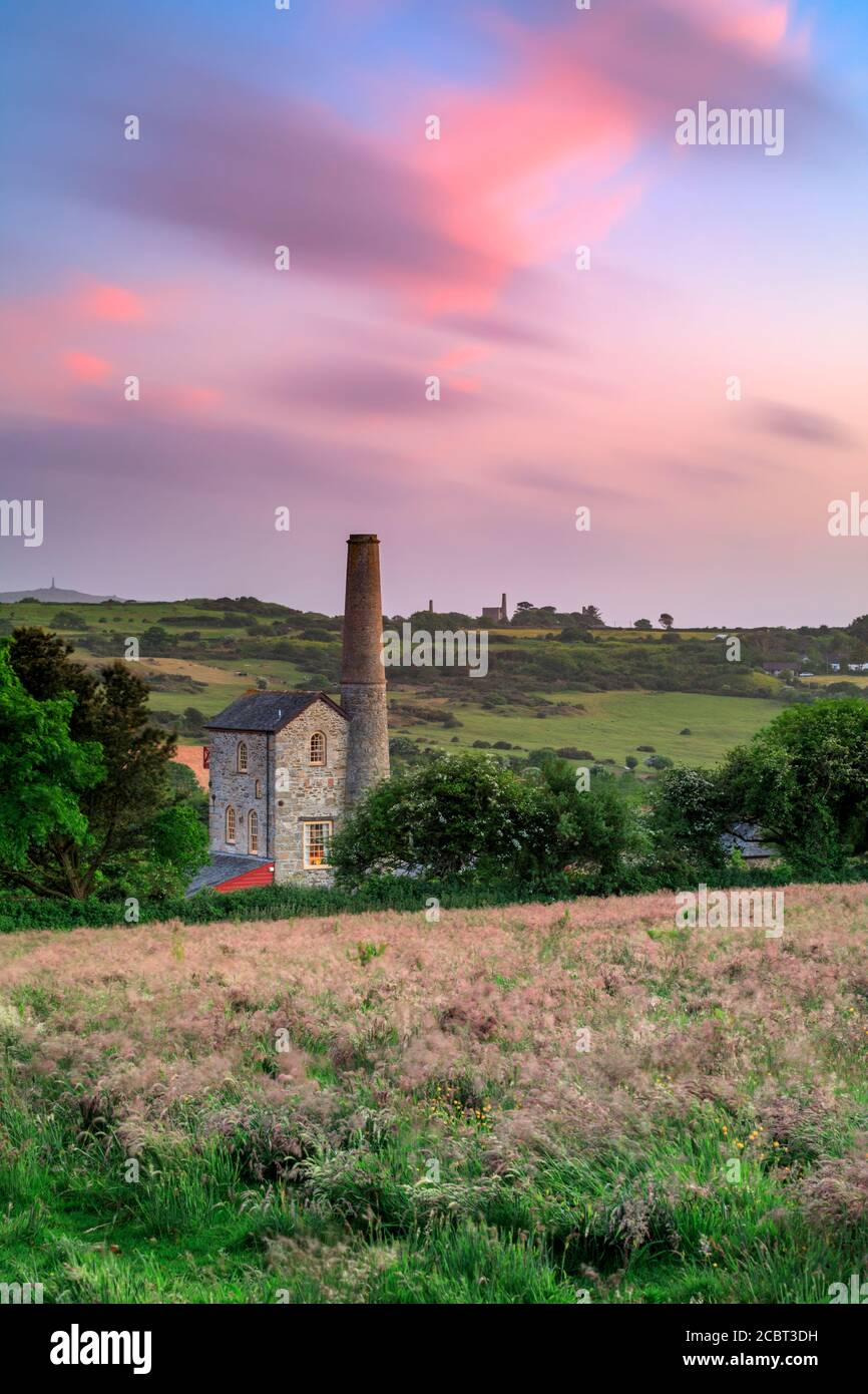 Wheal Rose Engine House with the engine houses at Wheal Peevor in the distance.  The image was captured on an evening in early June. Stock Photo