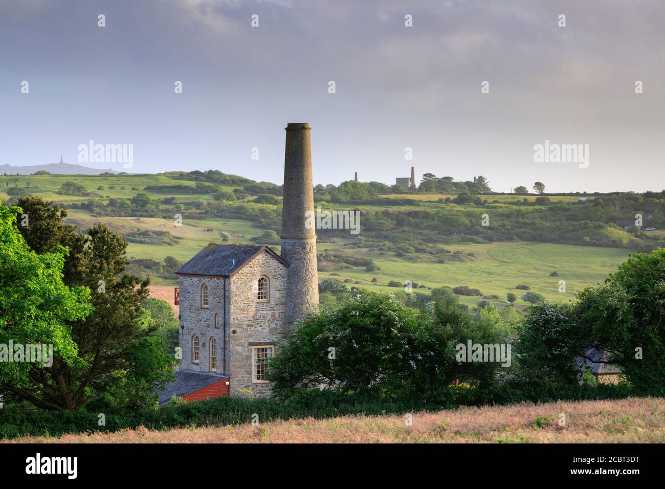 Wheal Rose Engine House with the engine houses at Wheal Peevor in the distance.  The image was captured on an evening in early June. Stock Photo