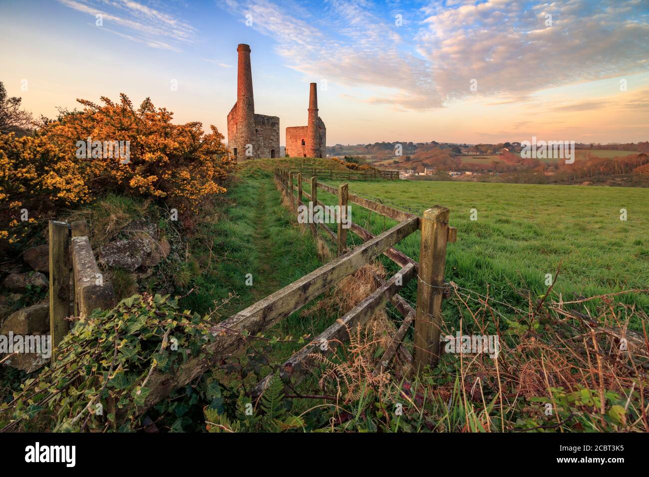 Wheal Unity Wood Engine Houses at Wheal Bush in Cornwall captured at sunrise from the entrance to the former industrial site. Stock Photo