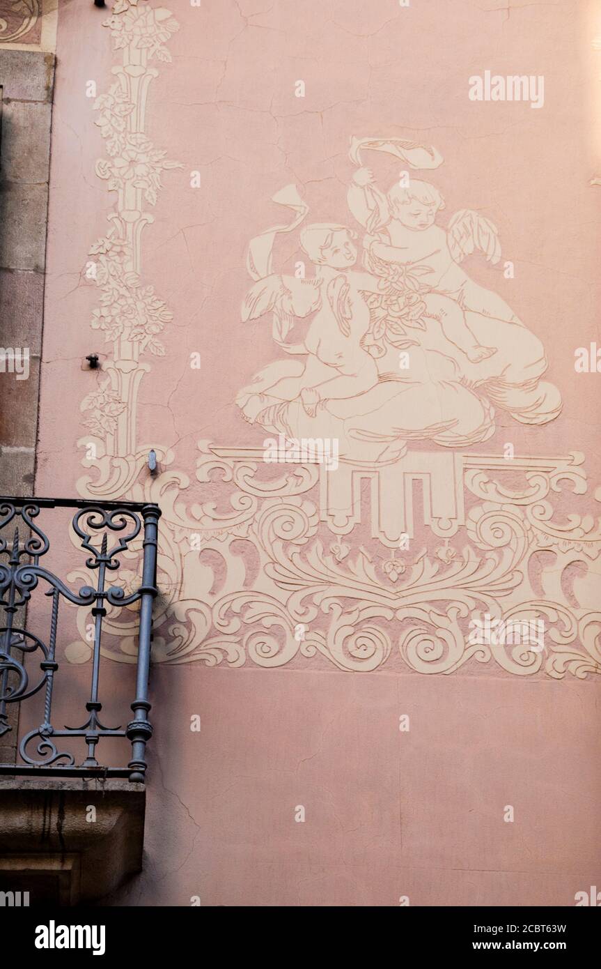 Sgraffito painting technoque, or scratching, contrasted with an iron balcony in Barcelona, Spain. Stock Photo