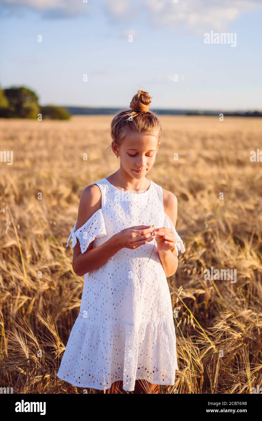Happy cute girl in wheat field outdoors Stock Photo - Alamy