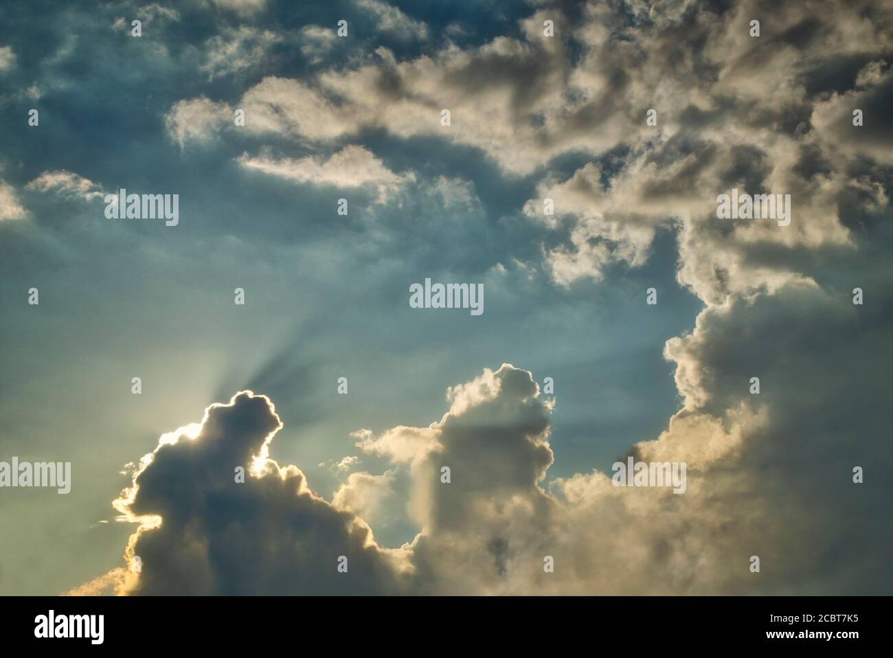 ENVIRONMENTAL CONCEPT: Sun going down behind dramatic cloud formation Stock Photo
