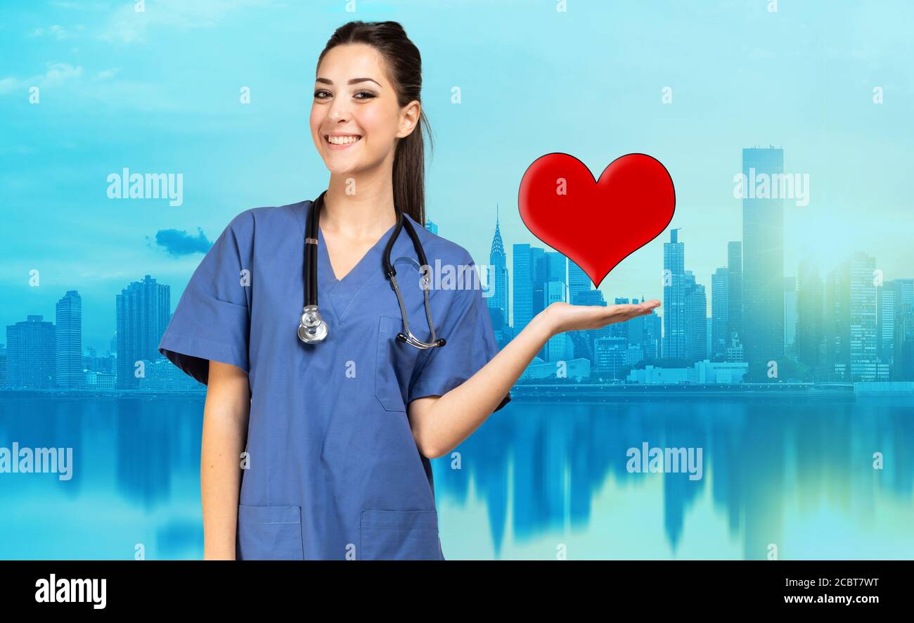 SMiling nurse holding a heart in her hand Stock Photo - Alamy