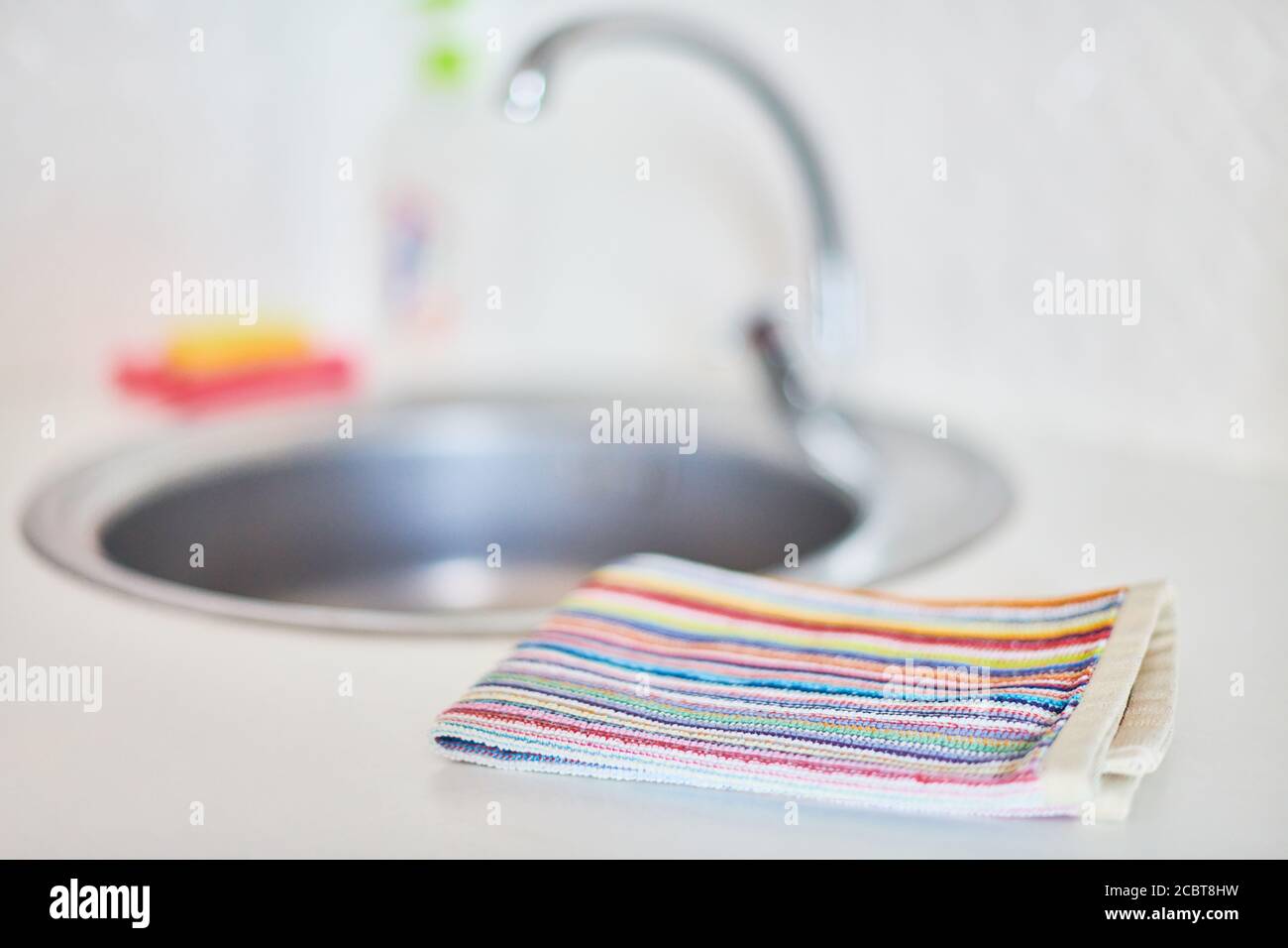 Kitchen towel and sink without dirty dishes background. Dishcloth on