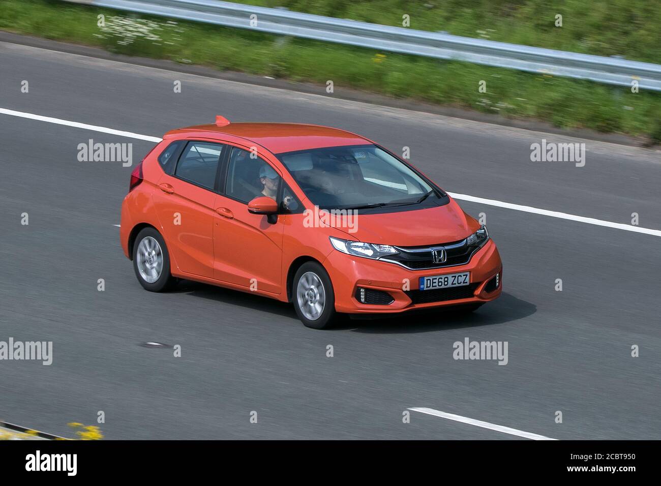 2018 Honda Jazz Se I-Vtec Orange Car Hatchback Petrol driving on the M6 motorway near Preston in Lancashire, UK. Stock Photo