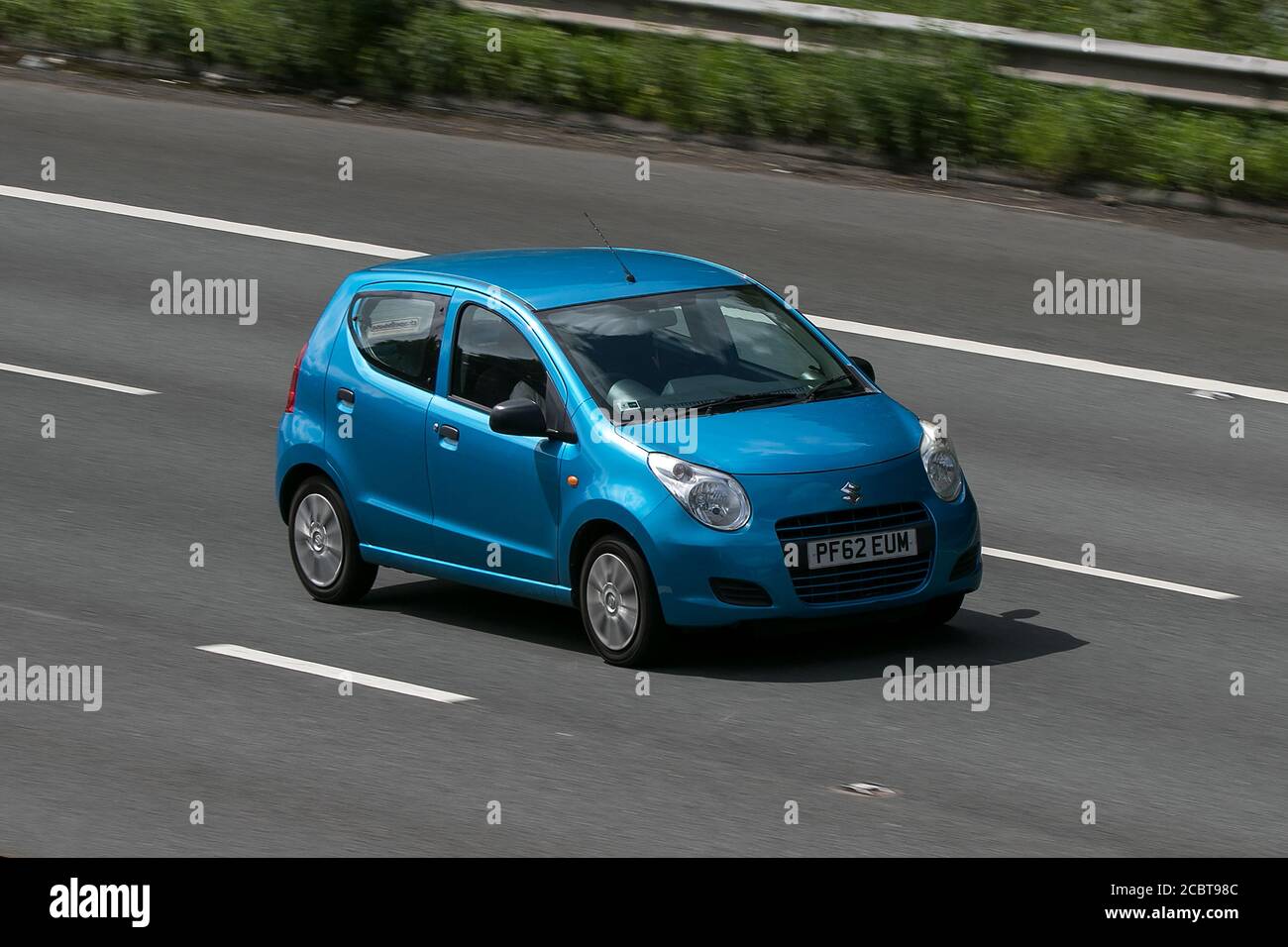 2013 Suzuki Alto Sz Blue Car Hatchback Petrol driving on the M6 motorway near Preston in Lancashire, UK. Stock Photo