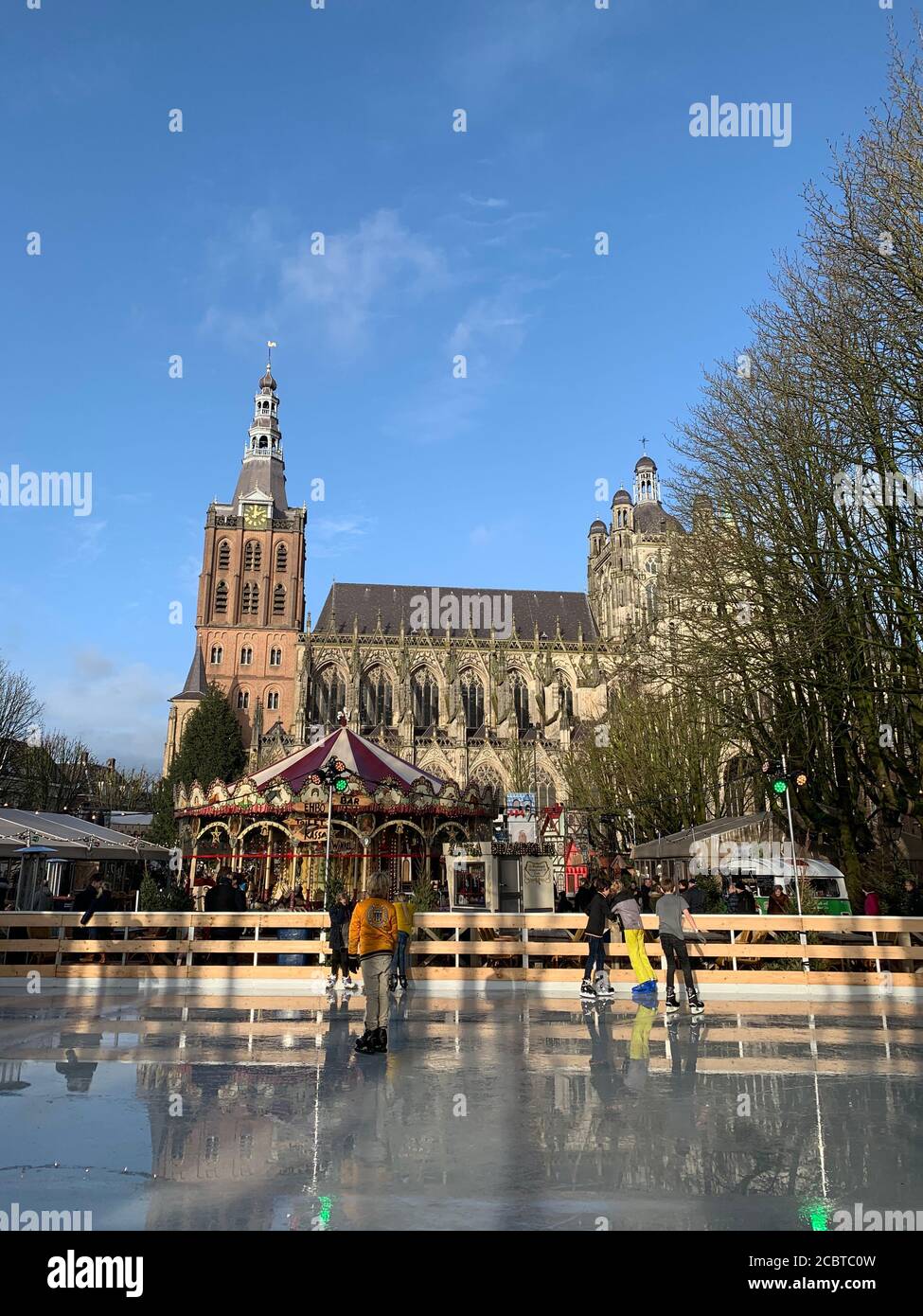 Children are ice skating in front of St John's Cathedral. Den Bosch / Netherlands Stock Photo